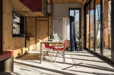 a kitchen with a table and two chairs on a patio at Cabin Zoobox 56 in Eastman