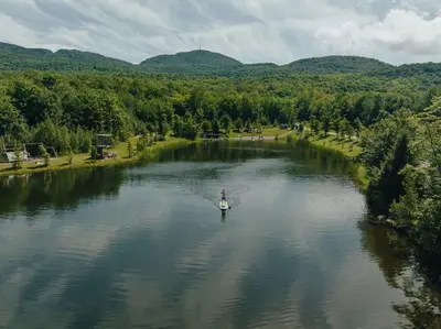 a person on a paddle board in a river at Cabin Zoobox 88 in Eastman