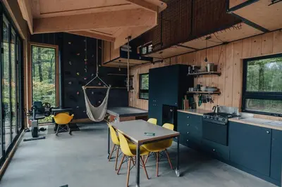 a kitchen with a table and yellow chairs in it at Cabin Zoobox 88 in Eastman