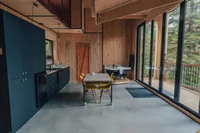 a kitchen with a table and chairs in a house at Cabin Zoobox 88 in Eastman