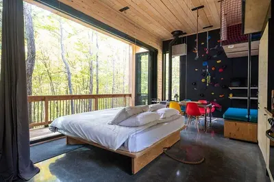 a bedroom with a bed and a large window at Cabin Zoobox 62 in Eastman
