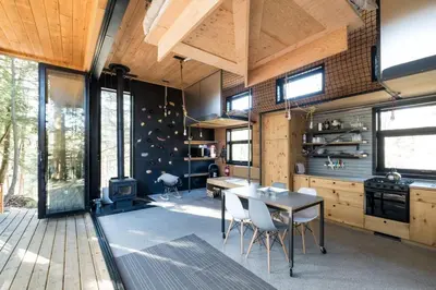 a kitchen with a table and chairs and a stove at Cabin Zoobox 65 in Eastman