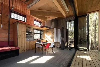 a room with a kitchen with a table and chairs at Cabin Zoobox 66 in Eastman