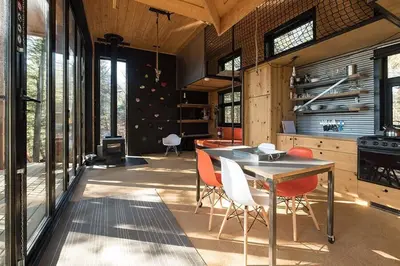 a kitchen with a table and chairs in a room at Cabin Zoobox 67 in Eastman