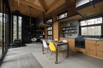 a kitchen with a table and yellow chairs in it at Cabin Zoobox 68 in Eastman