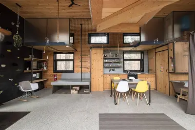 a room with a table and chairs in a building at Cabin Zoobox 68 in Eastman