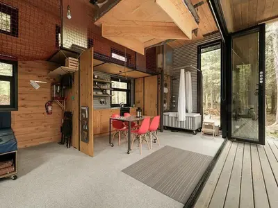 a room with a table and chairs in a house at Cabin Zoobox 82 in Eastman