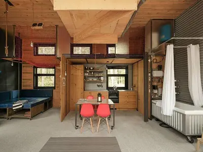 a room with a table and two red chairs at Cabin Zoobox 82 in Eastman