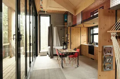 a kitchen with a table and chairs in a room at Cabin Zoobox 84 in Eastman