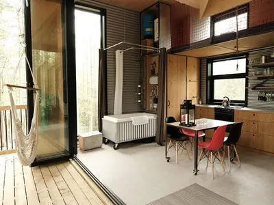a kitchen with a table and chairs and a tub at Cabin Zoobox 84 in Eastman
