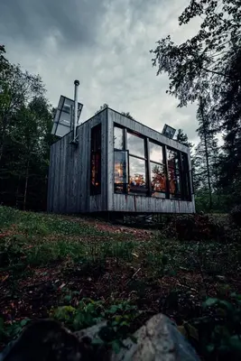 a small wooden house on a hill with windows at Cabin Zoobox 87 in Eastman