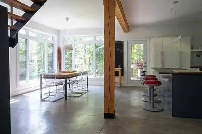 a kitchen with a table and chairs in a room at Cottage 35 Chemin Gilbert in Eastman