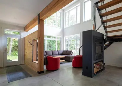 a living room with a couch and a fireplace at Cottage 35 Chemin Gilbert in Eastman