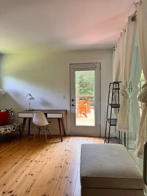 a room with a desk and a bed and a window at Cottage 61 des Cervidés in Eastman