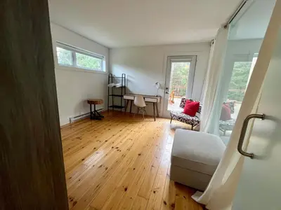 a room with a bed and a desk in it at Cottage 61 des Cervidés in Eastman