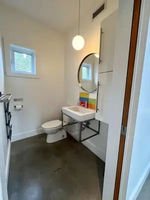 a bathroom with a sink and a toilet and a mirror at Cottage 61 des Cervidés in Eastman