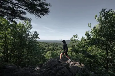 a man standing on top of a rock at Cottage 2 de la Chute in Eastman