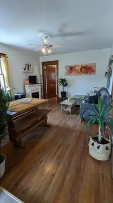 a living room with a table and plants in it at Gîte Richmond Inn in Richmond