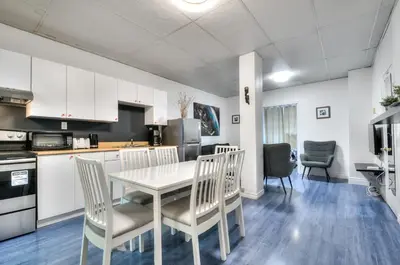a kitchen and dining room with a table and chairs at 100 METERS to METRO BEAUDRY - FULL APARTMENTS - 1 minute walk to the FAMOUS ST CATHERINE STREET - FAST WIFI - WASHER & DRYER ON SITE - Montcalm units in Montréal