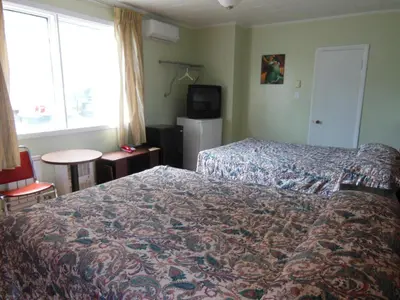 a hotel room with a bed and a window at Motel Pierre in Montréal