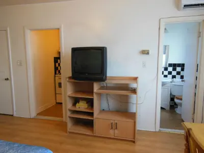 a tv sitting on a shelf in a room at Motel Pierre in Montréal