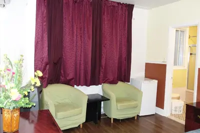 a room with two chairs and a table and a window at Motel Pierre in Montréal