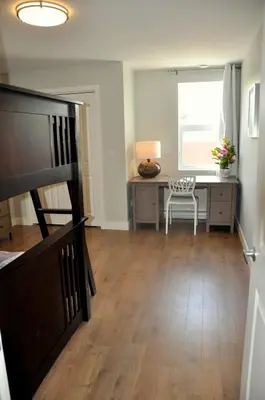 a living room with a desk and a chair at Le Mont-Royal Sky by HomeInMontreal in Montréal