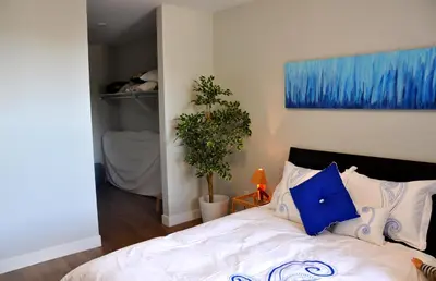 a bedroom with a bed with blue and white pillows at Le Mont-Royal Sky by HomeInMontreal in Montréal