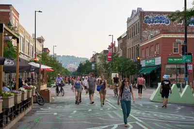 a group of people walking down a street at Le Mont-Royal Sky by HomeInMontreal in Montréal