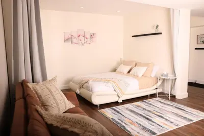 a bedroom with a white bed and a couch at bedford - Urban escape in Montréal