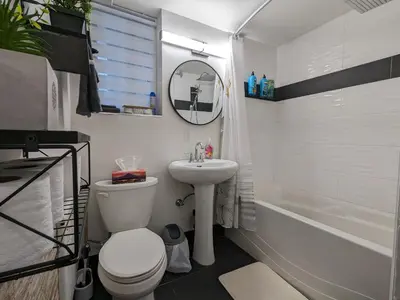 a bathroom with a toilet and a sink and a tub at bedford - Urban escape in Montréal