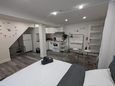 a living room with a bed and a kitchen at bedford - Urban escape in Montréal