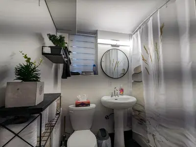 a bathroom with a sink and a toilet and a mirror at bedford - Urban escape in Montréal