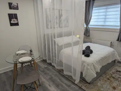a small bedroom with a bed and a table at bedford - Urban escape in Montréal