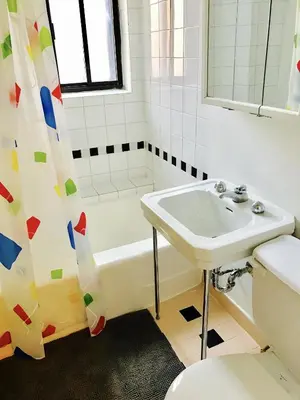 a bathroom with a sink and a tub and a toilet at Stylish Montreal Apartment: Comfortable Stay in the Golden Square Mile in Montréal