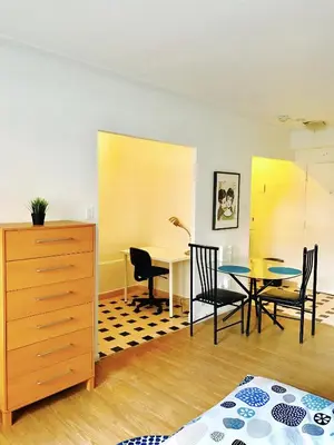 a room with a table and chairs and a dining room at Stylish Montreal Apartment: Comfortable Stay in the Golden Square Mile in Montréal