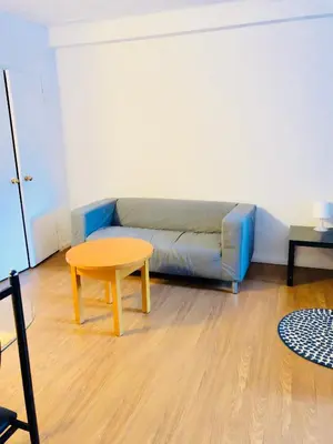 a living room with a couch and a table at Stylish Montreal Apartment: Comfortable Stay in the Golden Square Mile in Montréal