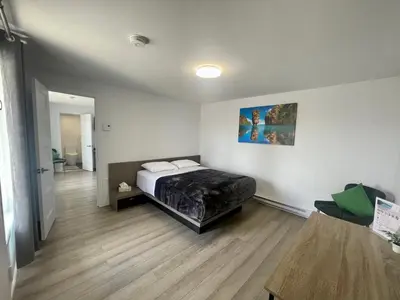 a bedroom with a bed in a room at Motel Saint Bruno in Saint-Bruno-de-Montarville