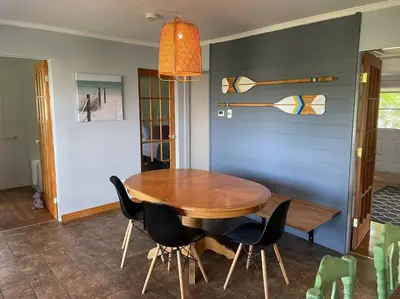 a dining room with a wooden table and chairs at Chalet de Mimi in Coaticook