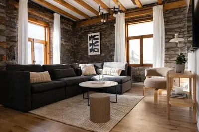 a living room with a couch and a table at Maison Place Royale by Luxury In Transit in Montréal