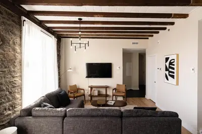 a living room with a couch and a tv at Maison Place Royale by Luxury In Transit in Montréal