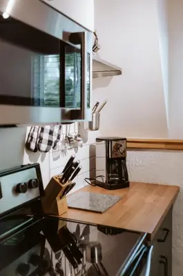 a kitchen with a counter with a coffee maker on it at Le Grizzli Orford in Orford