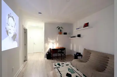 a living room with a couch and a table at Appartement de luxe avec piscine in Montréal