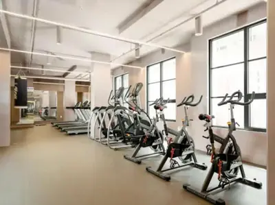 a gym with a row of treadms and cardio machines at Appartement de luxe avec piscine in Montréal