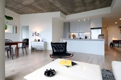 a living room with a couch and a table at Appartement de luxe avec piscine in Montréal