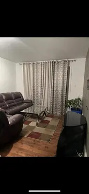 a living room with a couch and a table at Self-service small breakfast private Room 1 in Montréal