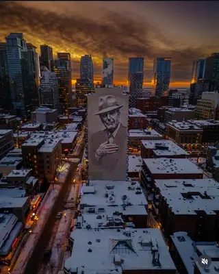 a large painting of a man in a hat on a building at Hello,CRESCENT in Montréal