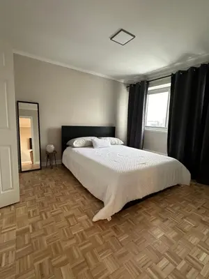 a bedroom with a large bed and a window at Hello,CRESCENT in Montréal