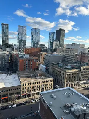 a view of a city skyline with tall buildings at Hello,CRESCENT in Montréal