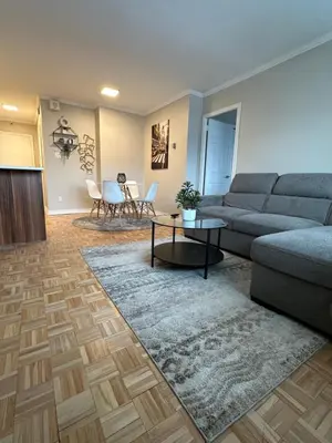 a living room with a couch and a table at Hello,CRESCENT in Montréal